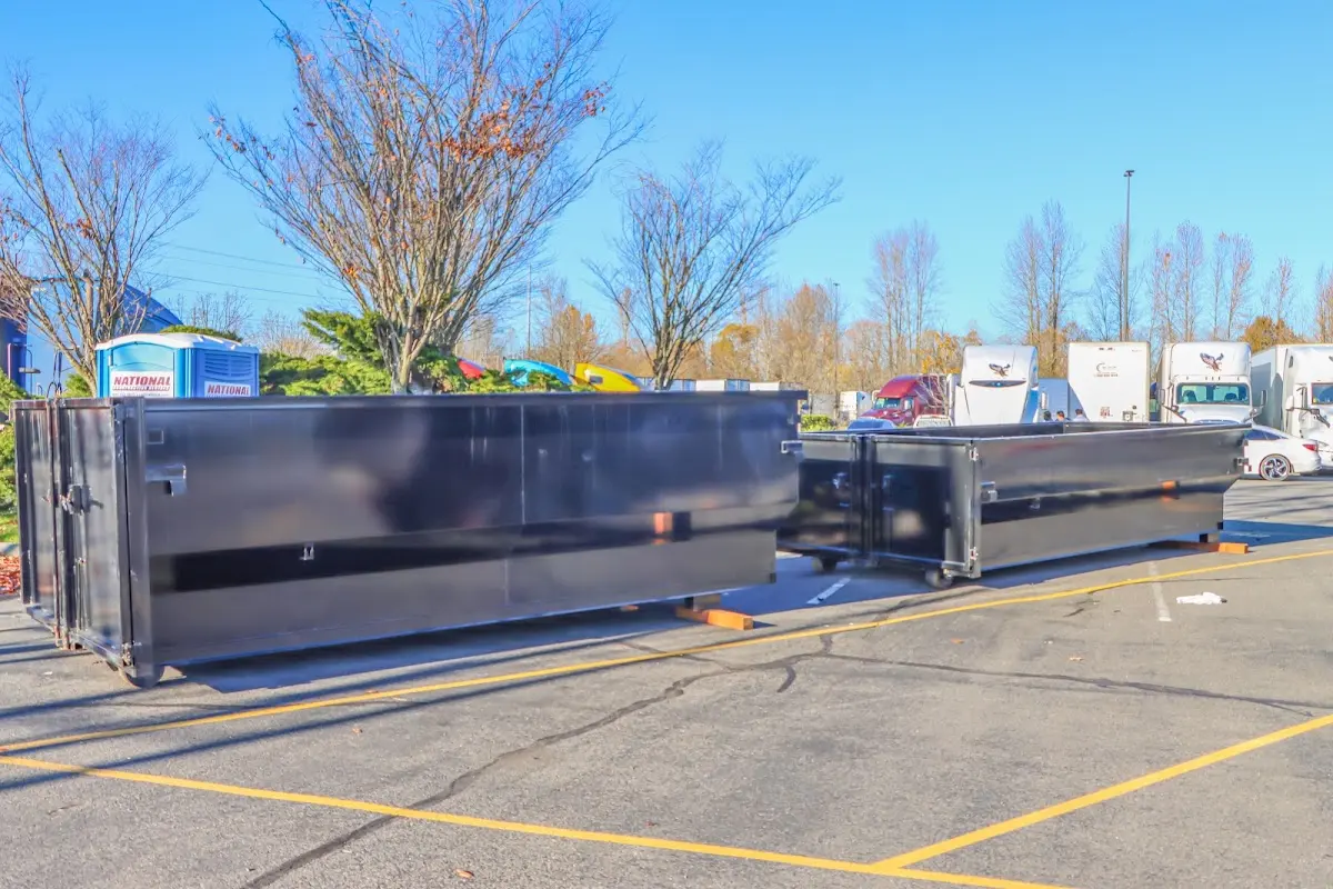 Professional dumpster rental service with roll-off container on residential driveway in Orangetree